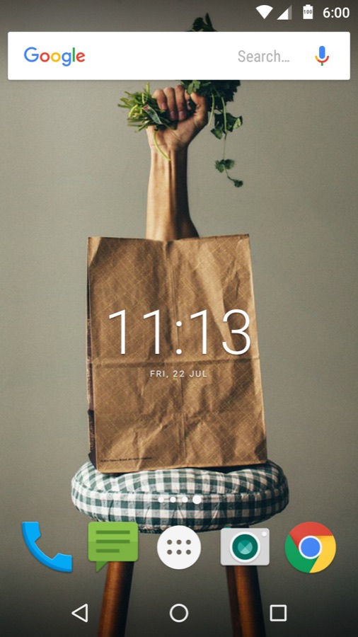 A hand raising a paper bag with a plant growing out of it, as a wallpaper on an Android home screen